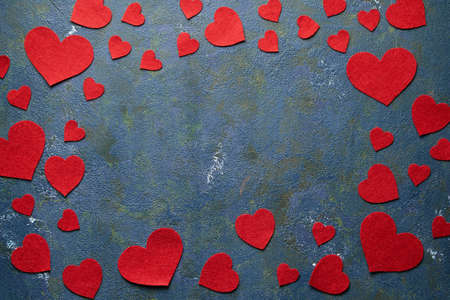 Concrete creative background with copy space and red heart made of wool for Valentines day or birthday. Flat lay. Top view.の写真素材