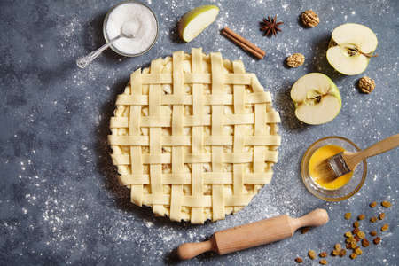 Apple pie traditional homemade thanksgiving pastry baked food preparation with ingridients flat lay on blue vintage background, top viewの写真素材