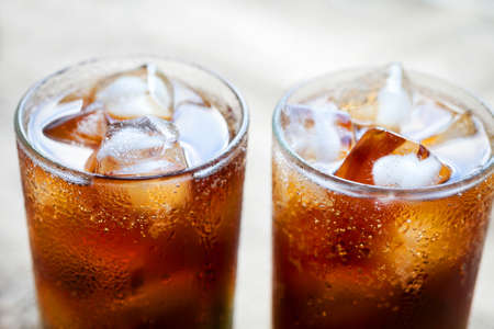 Two glasses of cola with ice. Close-up of a refreshing drink.の写真素材