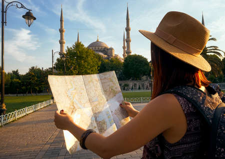 Young woman traveler tourist with map, tourism travel lifestyle