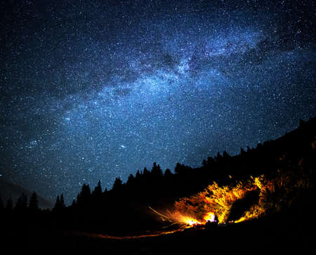 Milky way galaxy long exposure  night scene with campfire