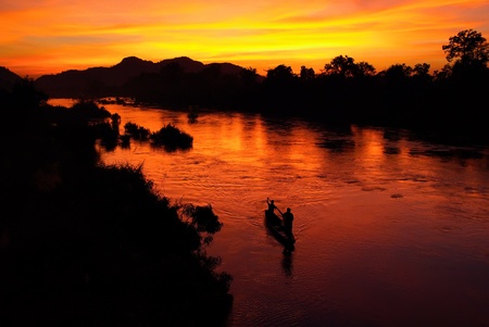 Fishing boat at sunset. Mekong, Laosの写真素材