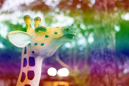 Smiling giraffe statue with gradient filter for background.の写真素材