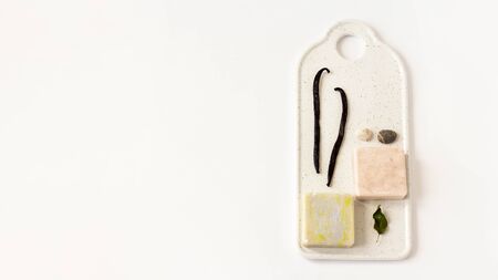 Two Soap from soy wax with vanilla and oliva,sea pebbles on white marble board on white background. Natural cosmetics. Ecological soap, top view, flat lay, overheadの写真素材