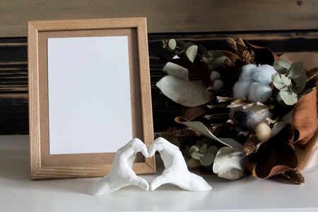 Home decor in honor of Valentines Day with 3D figures of hands folded with a white heart on a...