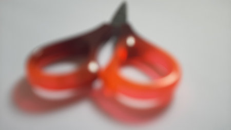 It's a quite small scissors usually used to cut paper, tape or something like that. The blades are made from metal and the grips are made from plasticの写真素材