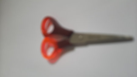 It's a quite small scissors usually used to cut paper, tape or something like that. The blades are made from metal and the grips are made from plasticの写真素材