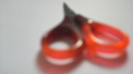 It's a quite small scissors usually used to cut paper, tape or something like that. The blades are made from metal and the grips are made from plasticの写真素材