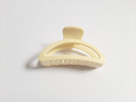 Single or One Cream or Milk White Hair Clip on isolated white background. Simple Elegant Plastic Hairpin Hair Grip Hair Claw or Hair Crab Accessories.の写真素材
