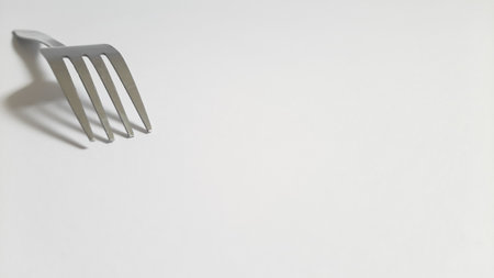 Metal or steel silver fork on isolated white backgroundの写真素材