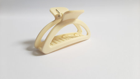 Single or One Cream or Milk White Hair Clip on isolated white background. Simple Elegant Plastic Hairpin Hair Grip Hair Claw or Hair Crab Accessories.の写真素材