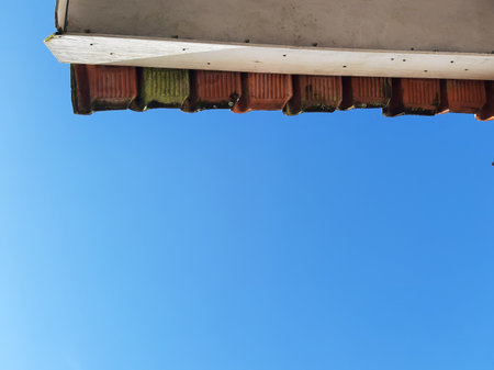 Rooftop terra cotta tiles on a shiny day and white ceiling. Copy space for text.の写真素材