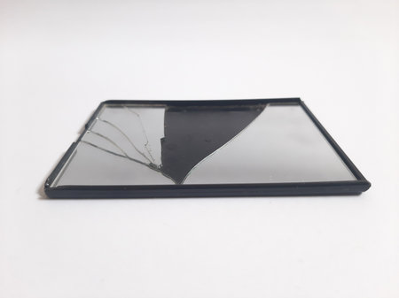 Black broken mirror on isolated white backgroundの写真素材