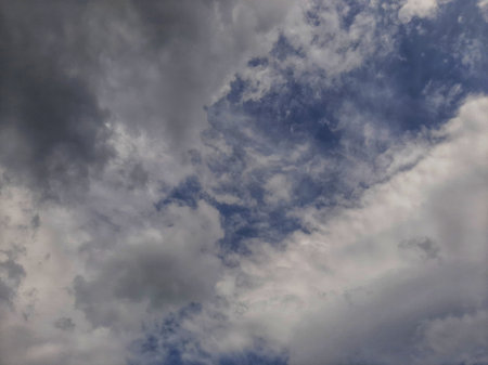 Cloudy and overcast blue sky with some sunlight.の写真素材