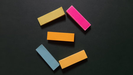 Pastel and Neon Sticky Notes or Paper Index or Page Marker or Flags Tabs or Note Adhesive Post Highlighter or Memo Pads for Highlighting Documents on Isolated Dark Backgroundの写真素材
