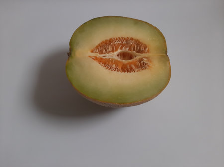 Top view fresh half cut melon on isolated white backgroundの写真素材