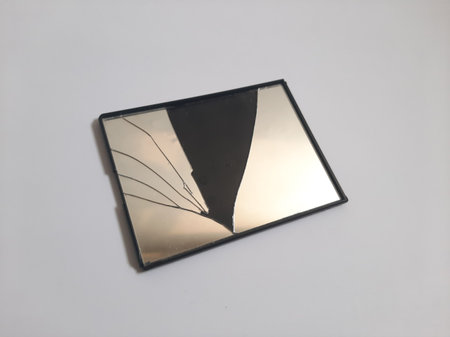Black broken mirror on isolated white backgroundの写真素材