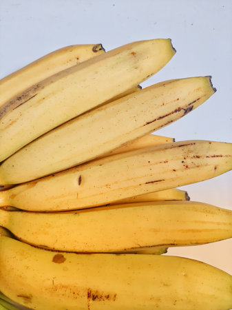Yellow bunch of banana close up on white backgroundの写真素材