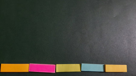 Pastel and Neon Sticky Notes or Paper Index or Page Marker or Flags Tabs or Note Adhesive Post Highlighter or Memo Pads for Highlighting Documents on Isolated Dark Backgroundの写真素材
