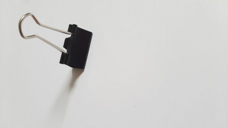 Binder or paper clip or office bind clip, stationery, realistic object on isolated white backgroundの写真素材