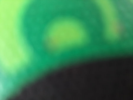 Black and green abstract blurred or unfocused or defocused textile texture backgroundの写真素材