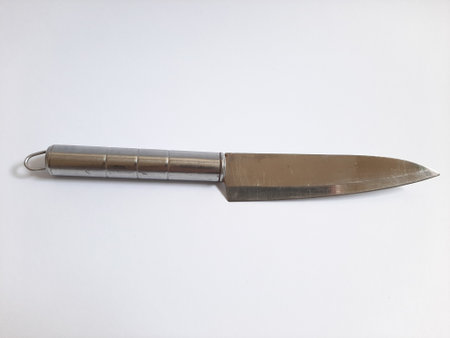 Single or one metal or steel silver knife on isolated white background with sunlightの写真素材