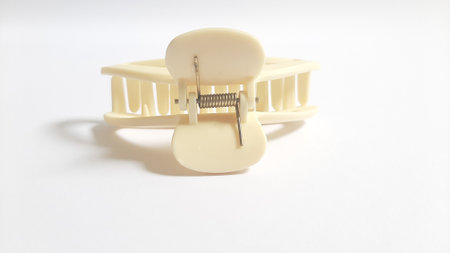 Single or One Cream or Milk White Hair Clip on isolated white background. Simple Elegant Plastic Hairpin Hair Grip Hair Claw or Hair Crab Accessories.の写真素材