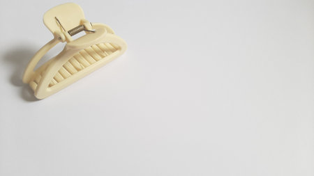 Single or One Cream or Milk White Hair Clip on isolated white background. Simple Elegant Plastic Hairpin Hair Grip Hair Claw or Hair Crab Accessories.の写真素材