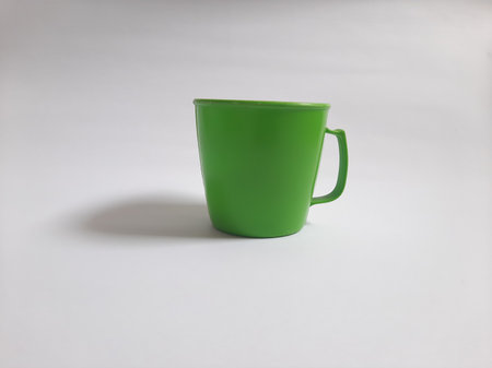 Front view empty green cup on isolated white backgroundの写真素材