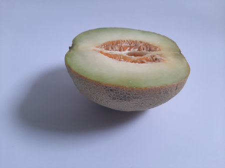 Front view fresh half cut melon on isolated white backgroundの写真素材