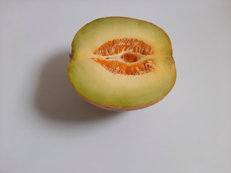 Top view fresh half cut melon on isolated white backgroundの写真素材