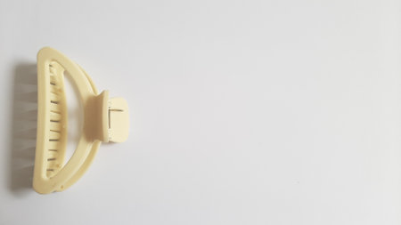 Single or One Cream or Milk White Hair Clip on isolated white background. Simple Elegant Plastic Hairpin Hair Grip Hair Claw or Hair Crab Accessories.の写真素材