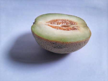 Front view fresh half cut melon on isolated white backgroundの写真素材
