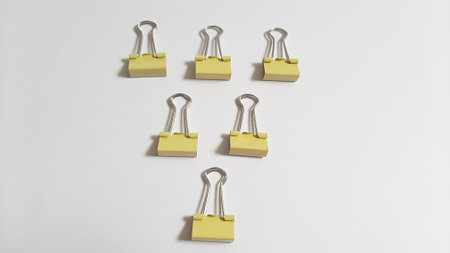 Binder or paper clip or office bind clip, stationery, realistic object hierarchy metaphor on isolated white backgroundの写真素材