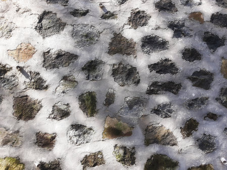 Stacked rocks and cement wall texture background with shadow for constructionの写真素材