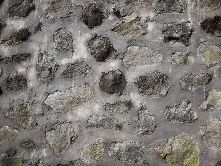 Stacked rocks and cement wall texture background with shadow for constructionの写真素材