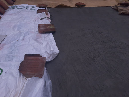 Roof tile on wet cement floor covered by white plastic bagの写真素材