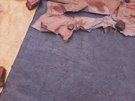 Roof tile on wet cement floor covered by white plastic bag and tarpaulinの写真素材