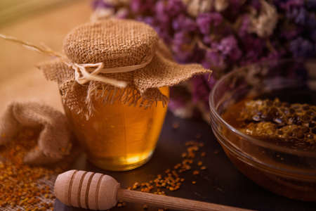 Still life with sweet honey, honeycomb, pollen and propolisの写真素材