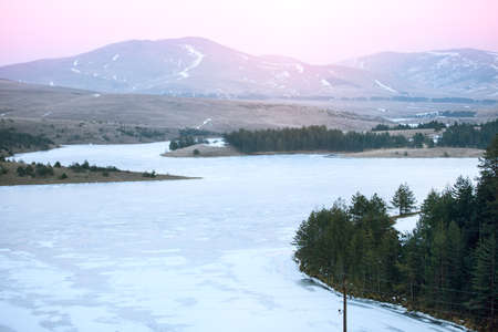 magic winter landscape of fields and mountains on sunset light