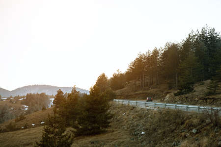 Car drives on winding road on mountain for vacationの写真素材