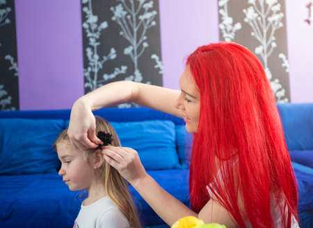 Mom and young daughter at home having funの写真素材