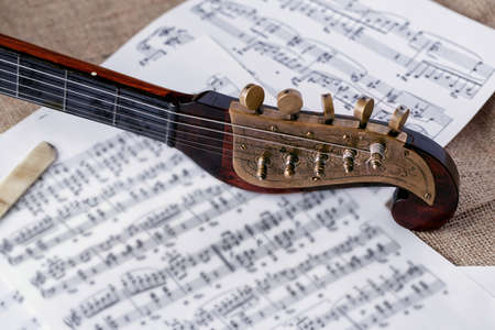 detail of old wooden instrument on sheet music backgroundの写真素材