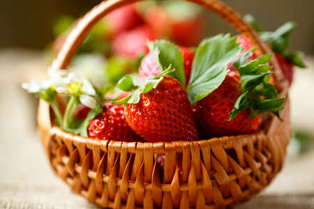 Ripe fresh strawberries in basket backgroundの写真素材