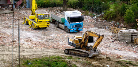 Excavators machine in construction site and vehicle