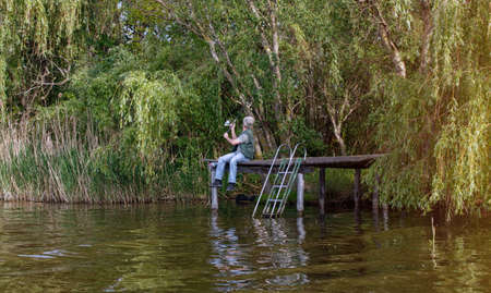 Man fishing on river bank
