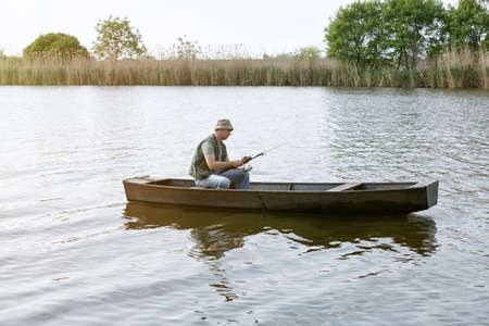young man in small boat on fishing day