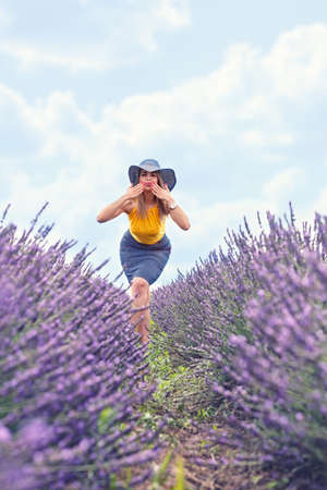 Beautiful cheerful young girl on lavender fieldの写真素材