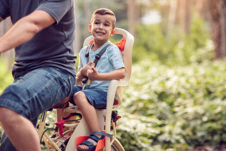 Family sport and healthy lifestyle- Happy little boy on bicycle in parkの写真素材