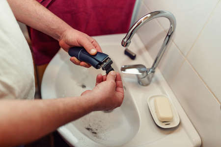 Morning hygiene, Close up cleaning of electric razor after shaving backgroundの写真素材